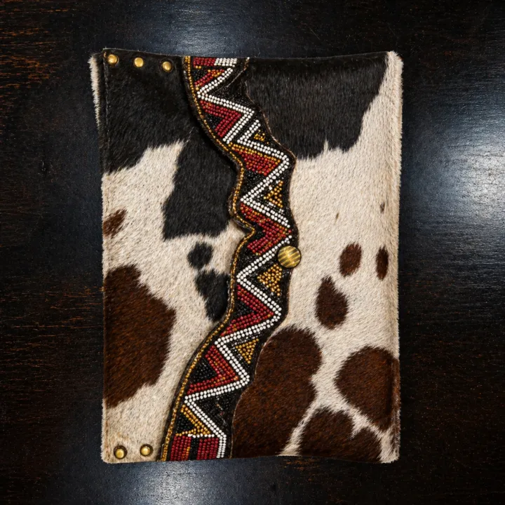 Inkanyezi — black and white Nguni sleeve with hand-beaded red zigzag trim