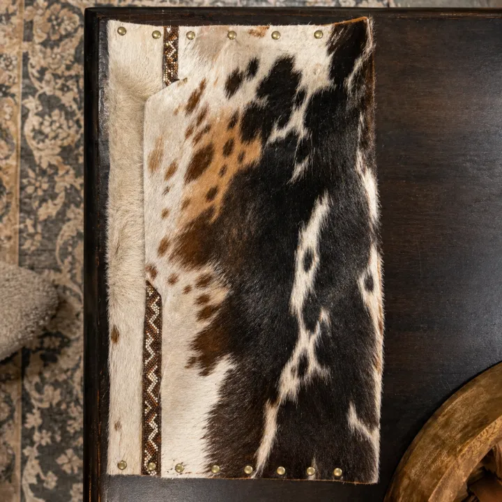 Ilanga — black and white Nguni hide sleeve, flap open